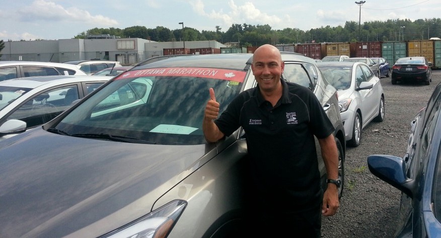 Race Director poses with SUV ready for shipment