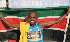 Nicholas Bore raises Kenyan flag at 2015 Tamarack Ottawa Race Weekend