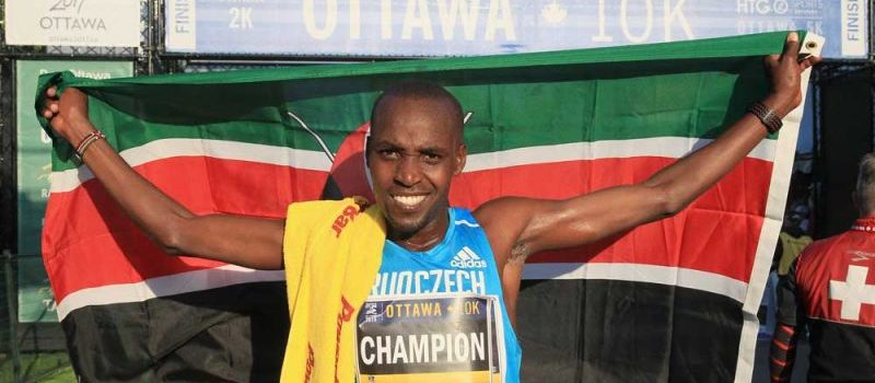 Nicholas Bore raises Kenyan flag at 2015 Tamarack Ottawa Race Weekend